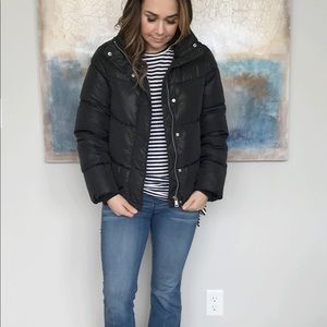 Black high collar puffer jacket.